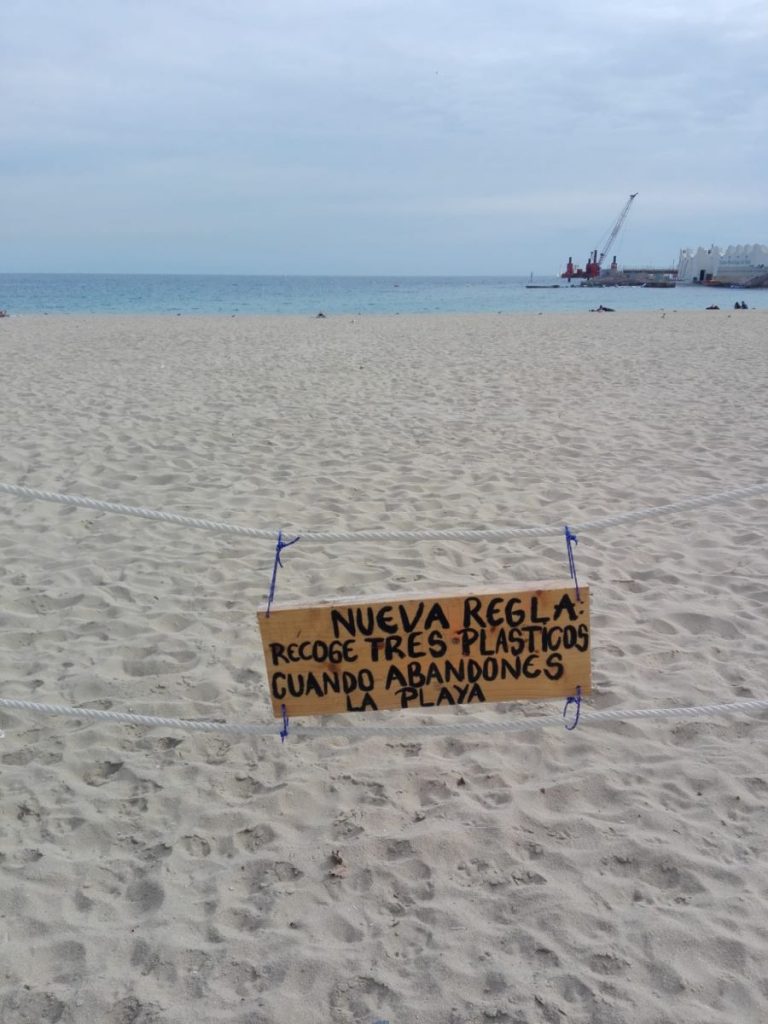 New rule: collect 3 pieces of plastic to encourage recycling on barcelona beach in spain
