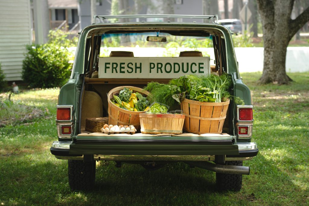 photo of a pickup truck filled with fresh produce.